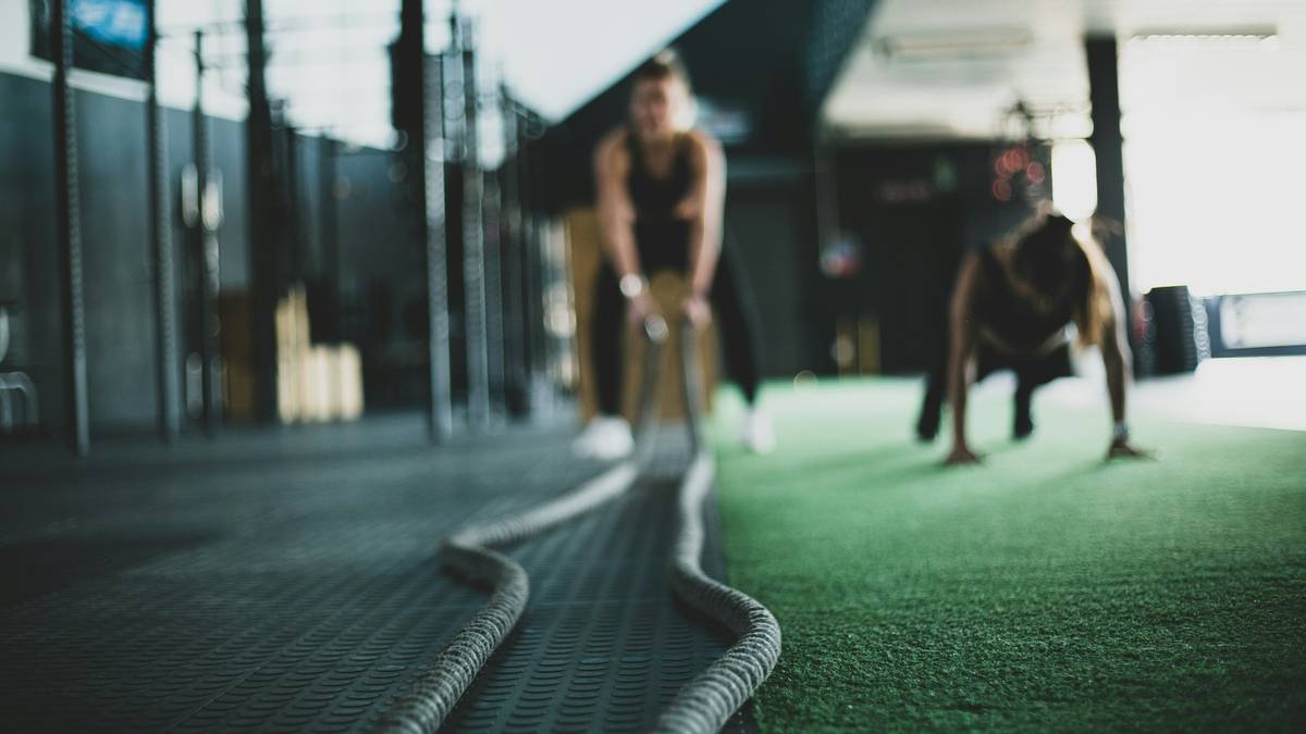 woman doing squats and push-ups in home gym as part of her exercises for weight loss routine